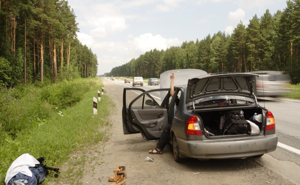 A broken car parked beside the road